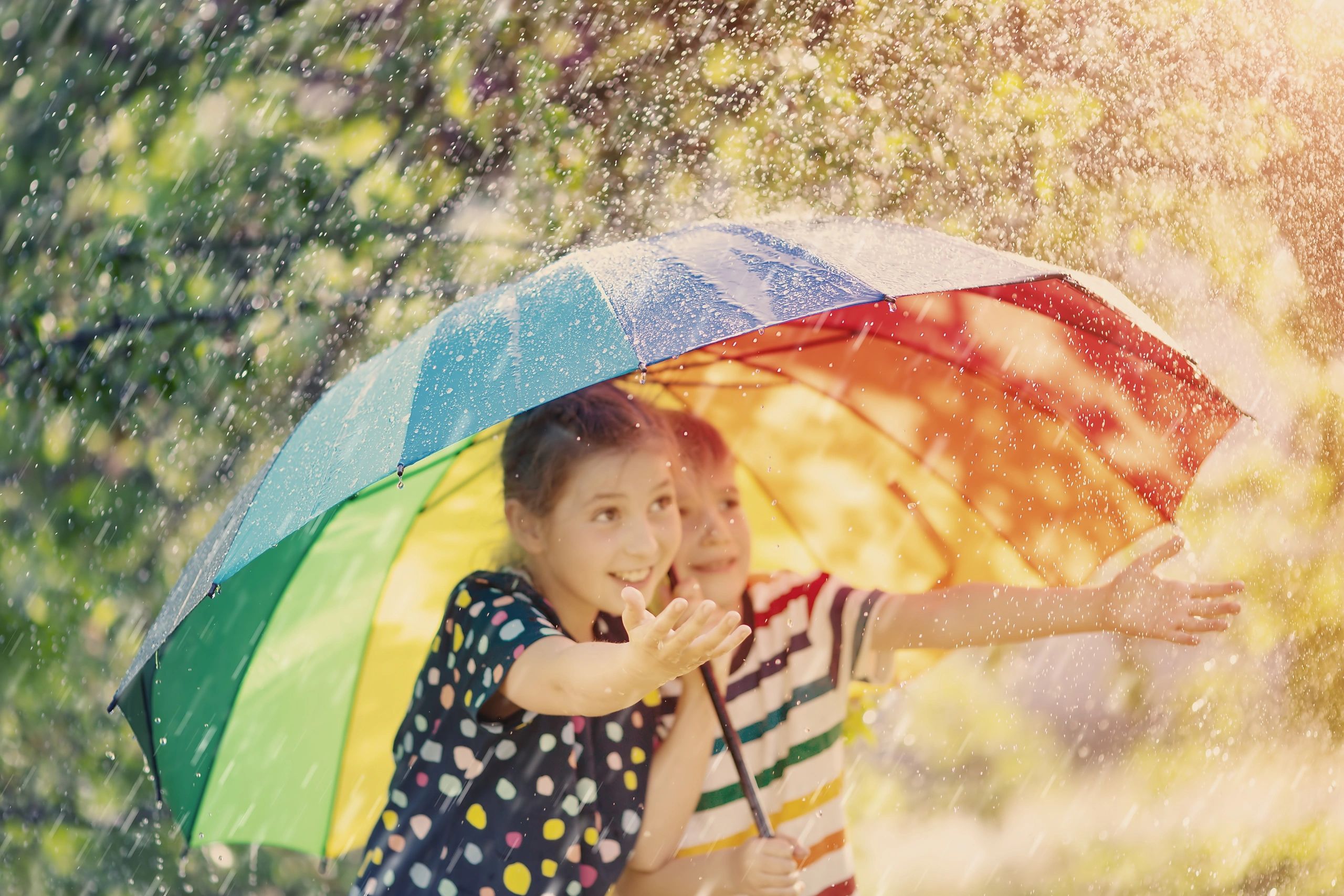 two children under an umbrella