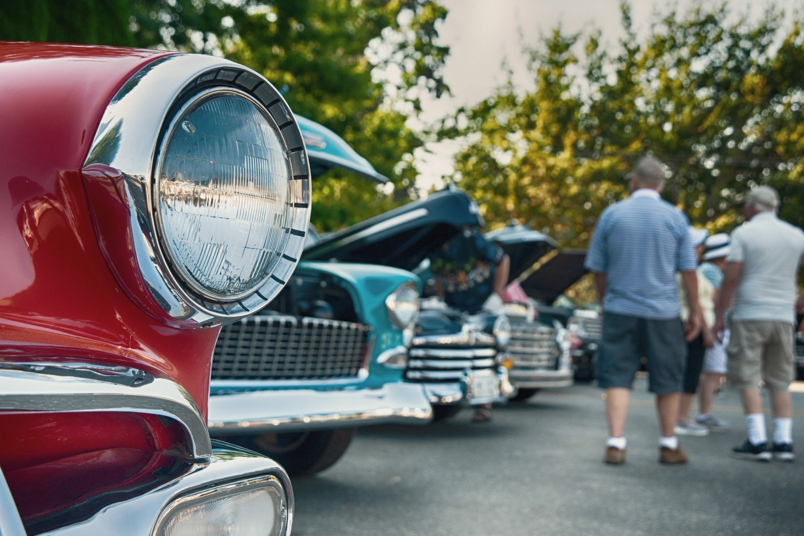 Vintage or classic auto show with cars lined up while people look at them