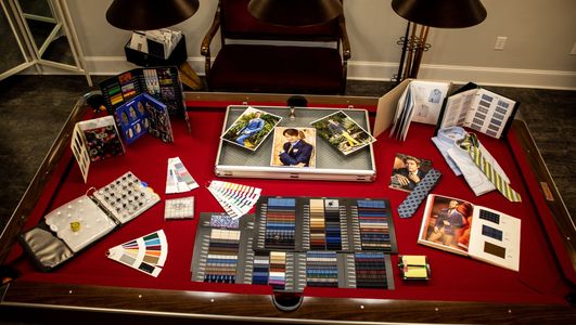 Display case of fabric swatches for custom suits and custom shirts in men's clothing store