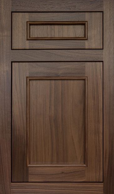 Close-up of a dark wooden cabinet door with raised panel design.