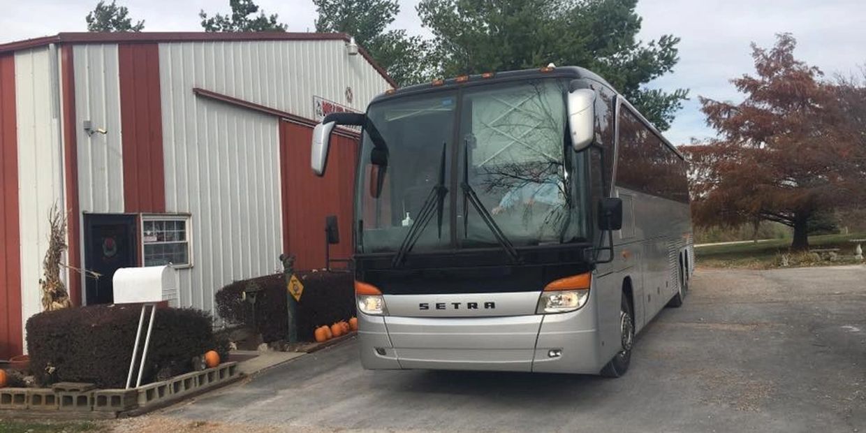 A motor coach parked outside our pecan shed and gift store.