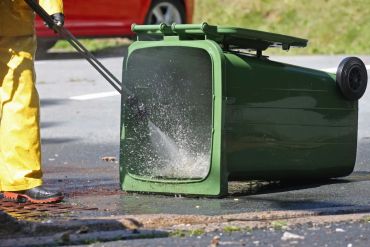 Pressure washing a green bin