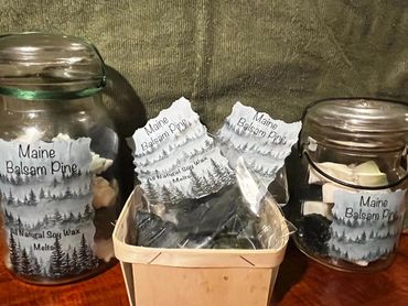 Jars and a basket of Maine Balsam Pine soy wax melts with pine tree labels.