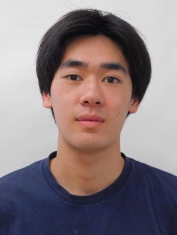 Young man with short black hair and a plain navy blue shirt.