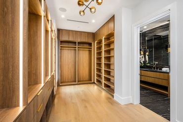 Modern walking closet with wooden cabinetry and minimalist design.