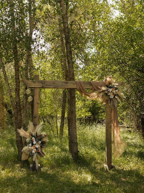 wooden arbor backdrop rental for summer or fall wedding ceremony in rexburg, idaho