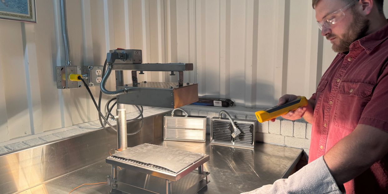 Man using equipment with protective gear in a lab.