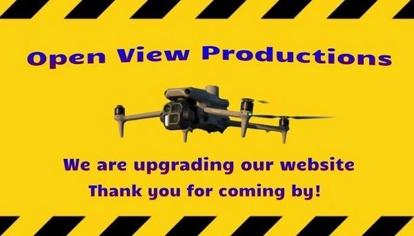 Open View Productions upgrading website with drone image on yellow background.