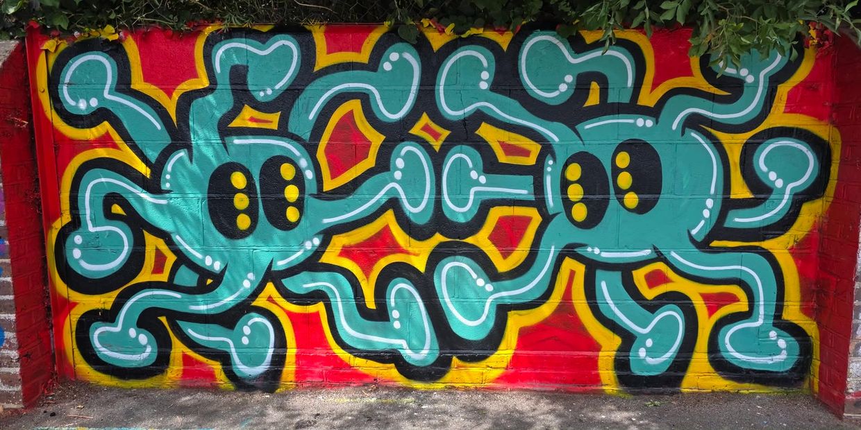 Colorful cartoonish octopuses painted on a wall.