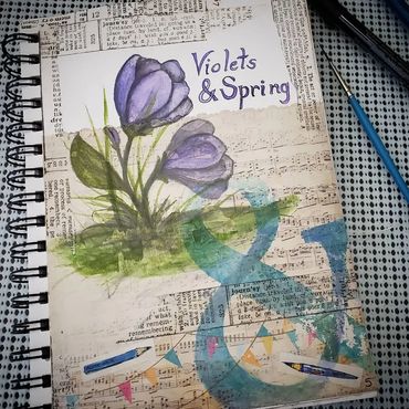 violets in purple over collages text in sketchbook