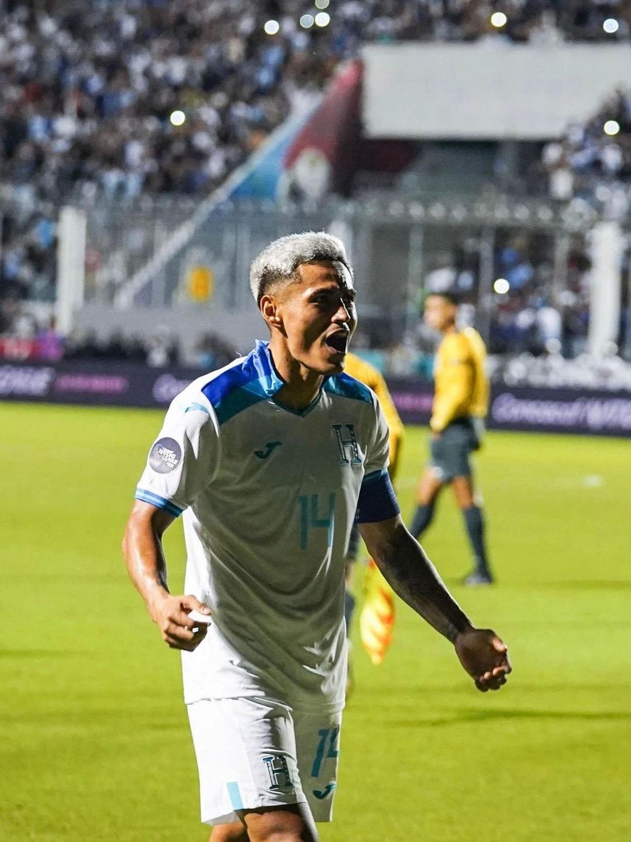 Excited soccer player celebrating on the field.