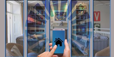 Person controlling smart home devices via smartphone app in modern living room.