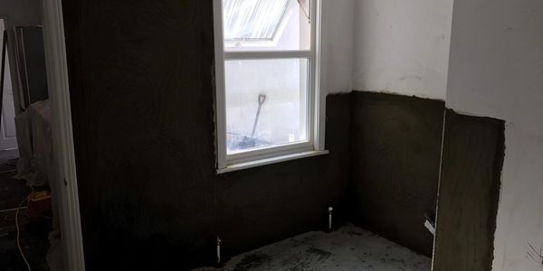 Damp proofing with a water proof render after a damp course has been injected.