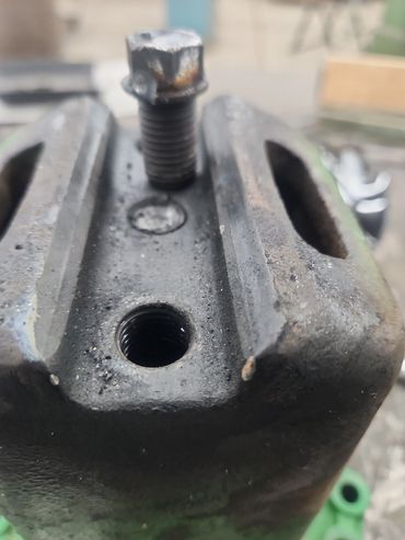 Piece of steel with a broken bolt in it.