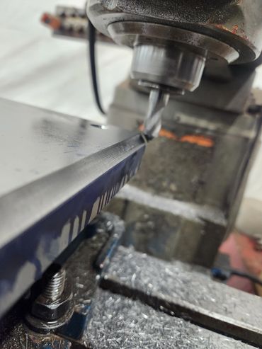 Milling machine being used to cut a piece of steel.