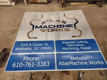 Atlas Machine Works business sign with contact information.