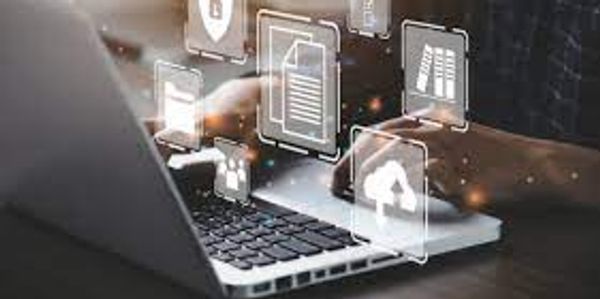 Person using laptop with floating digital icons.
