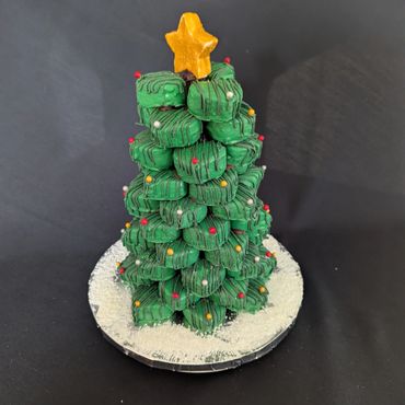 Edible Christmas tree made of green treats with a star on top.