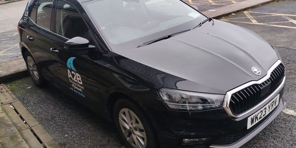 Black Driving School car with logos