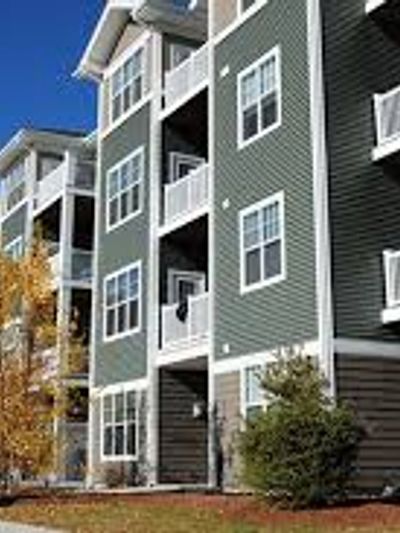 Exterior view of a multi-story apartment building with balconies.