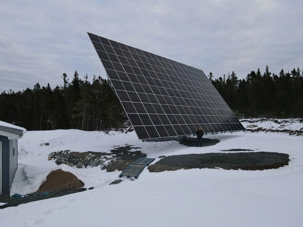 Ninety panel solar tracker platform at 30 degrees from vertical.  Winter snow is on the ground.