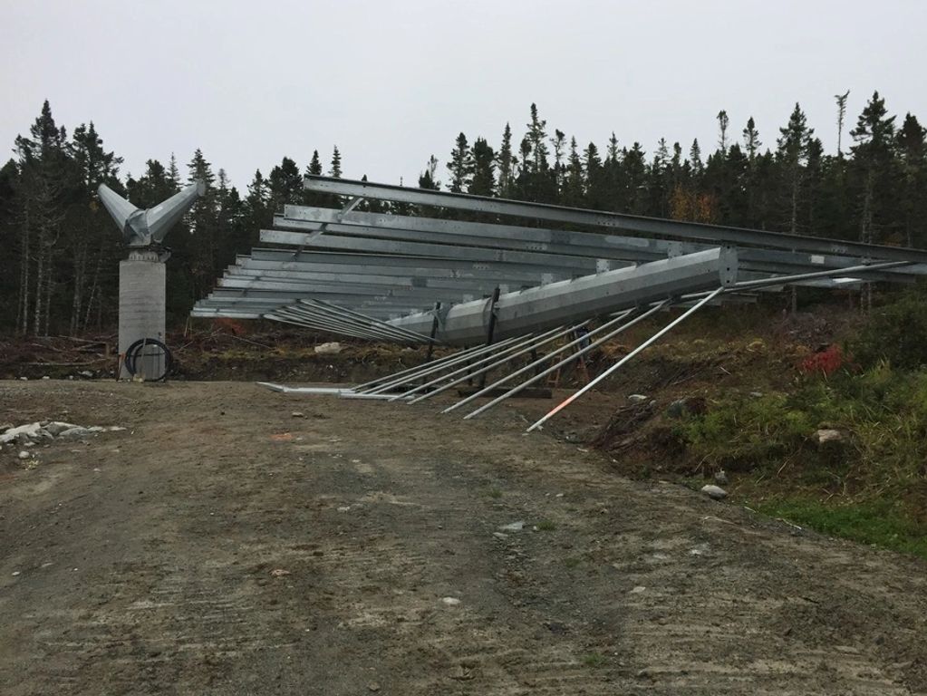 Partially assembled 2-axis solar tracker platform and concrete pedestal with drive unit on it.