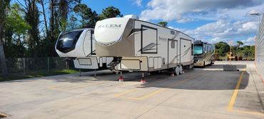 open air storage with RVs and boats with concrete pads