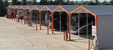 Covered storage with RVs inside with concrete pads with water hoses