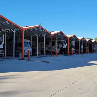 Covered storage with RVs inside with concrete pads with water hoses