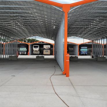 Covered storage with RVs inside with concrete pads with electric