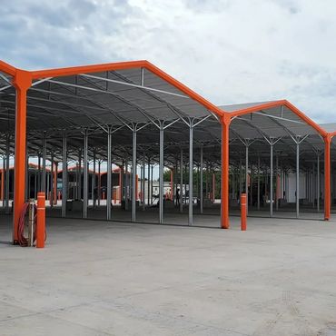 Covered storage with RVs inside with concrete pads and open air