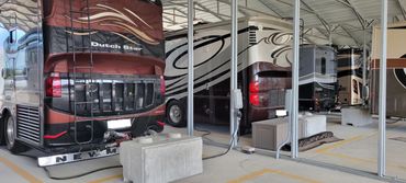 Covered storage with RVs inside with concrete pads with electric