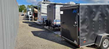 open air storage with RVs and boats with concrete pads and electric