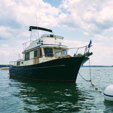 A boat anchored in calm waters under a partly cloudy sky.