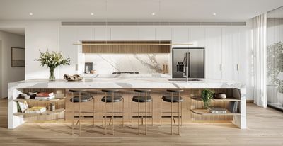 Modern kitchen with a marble island and bar stools.
