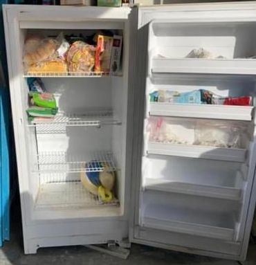 Mostly empty standing freezer