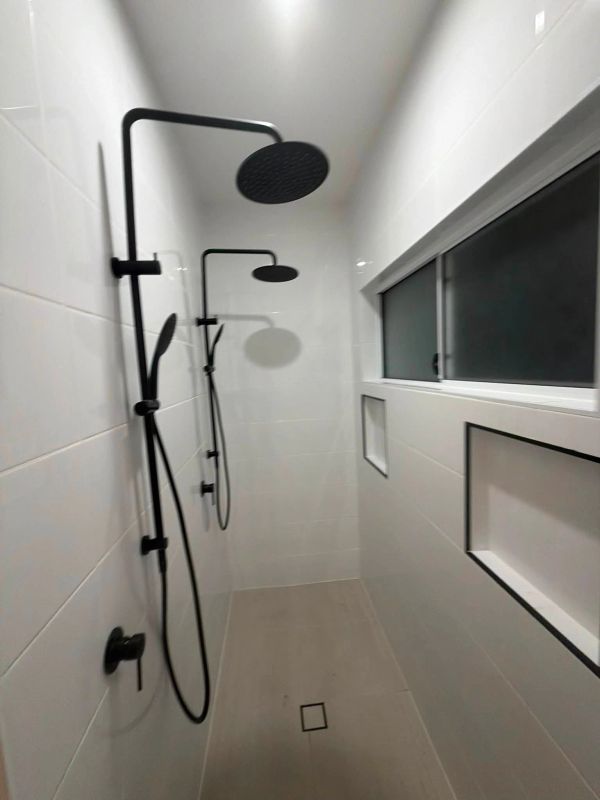 Modern minimalist shower with black fixtures.