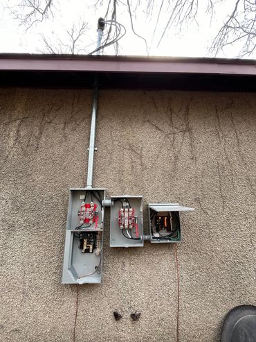 An electrical service installed on a garage for Electric Vehicle (EV) charging.