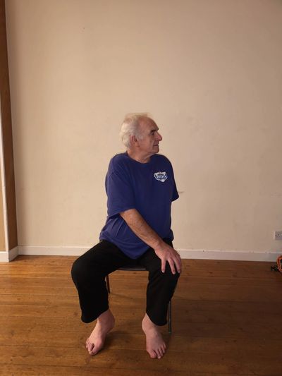     A disabled student practicing chair yoga