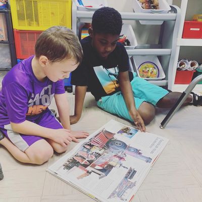 students sharing while reading a book
