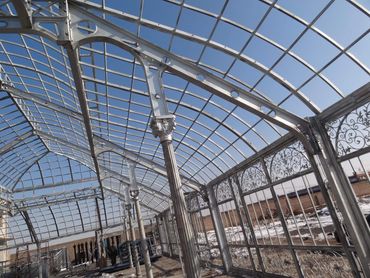 Close-up of a classic gothic victorian greenhouse during construction. The glass is not yet added