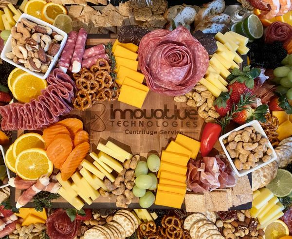 Gourmet charcuterie board with meats, cheeses, fruits, nuts, and crackers arranged beautifully.