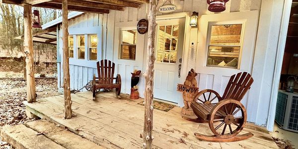 Rustic porch with wooden rocking chairs and welcoming decor.