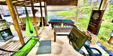 Covered outdoor space with games and exercise equipment.