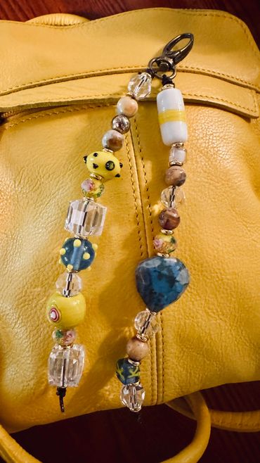 Colorful beaded accessory on a yellow bag.
