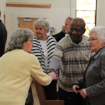 Members of the church greet each other in Christian fellowship.