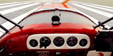 View from inside a small aircraft cockpit on the runway.