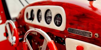 Close-up of a vintage car dashboard with gauges.
