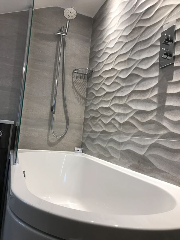 3D tiles with specifically placed lighting to enhance shadowing effect on tiles in shower over bath.