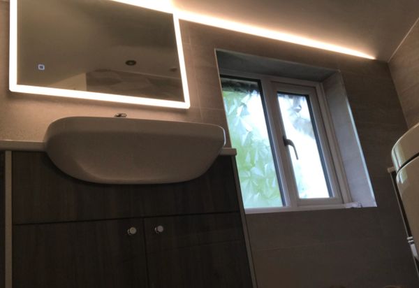 LED lighting with semi recessed basin. LED lighting for a gentle glow on ceiling to enhance slope.